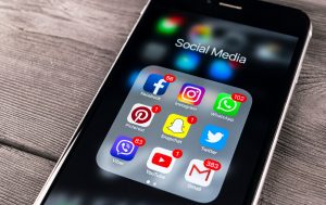 social media app icons on a mobile phone screen