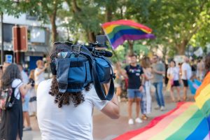 Bradcast journalist covering a Pride Day demonstration