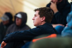 Side profile of a man wearing a black shirt